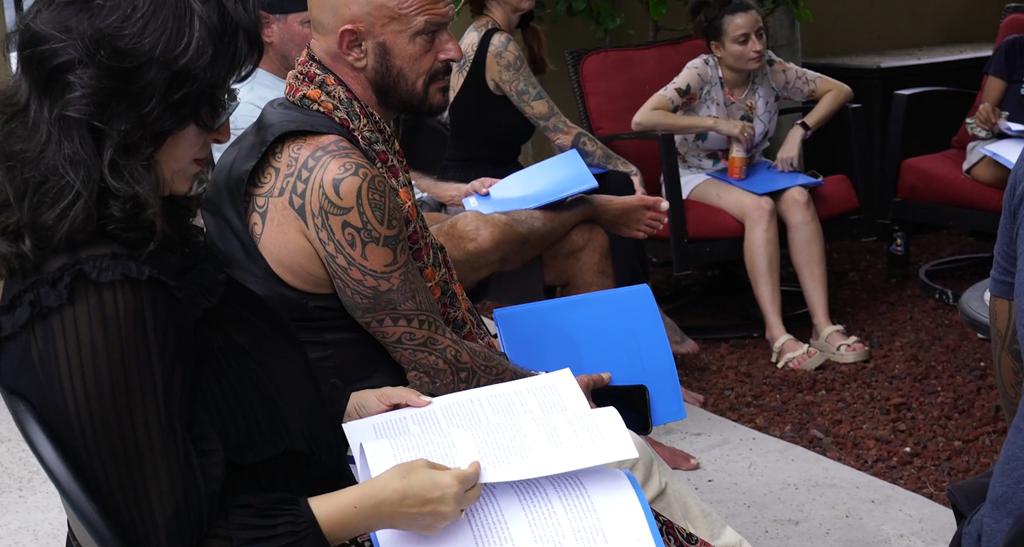 Healing Heroes Hawaii retreat participants reading and journaling together outdoors